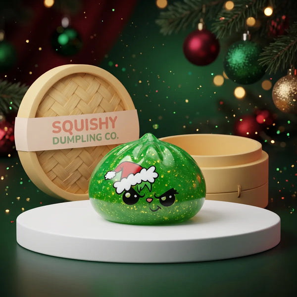 Grumpy Christmas Evil Dumpling Squishy on a white studio podium beside a steamer basket
