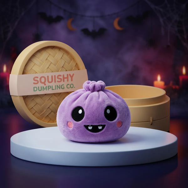 Velvet Halloween Vampire Dumpling Squishy Plush on a white studio podium beside a steamer basket