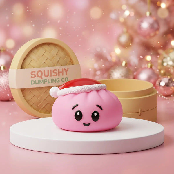 Sugar Pink Christmas Hat Dumpling Squishy on a white studio podium beside a steamer basket