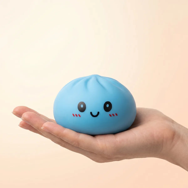 Blue dumpling squishy held in hand lifestyle shot
