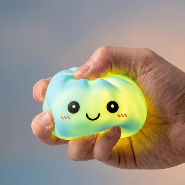 Hands playing with the blue squishy dumpling light