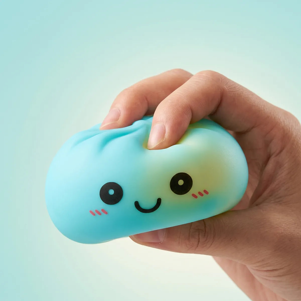 Blue squishy dumpling light being squeezed showing slow rising foam