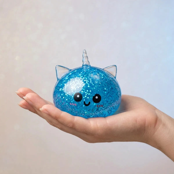 Hand holding the 5.5 cm blue unicorn glitter dumpling squishy to show its size