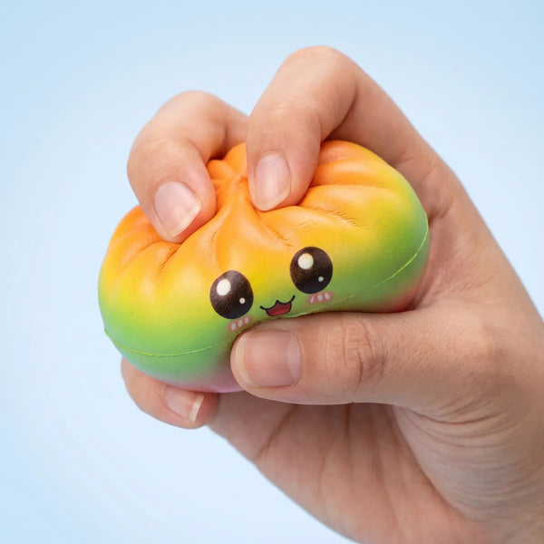 Hands playing with the charming mystery dumpling squishy