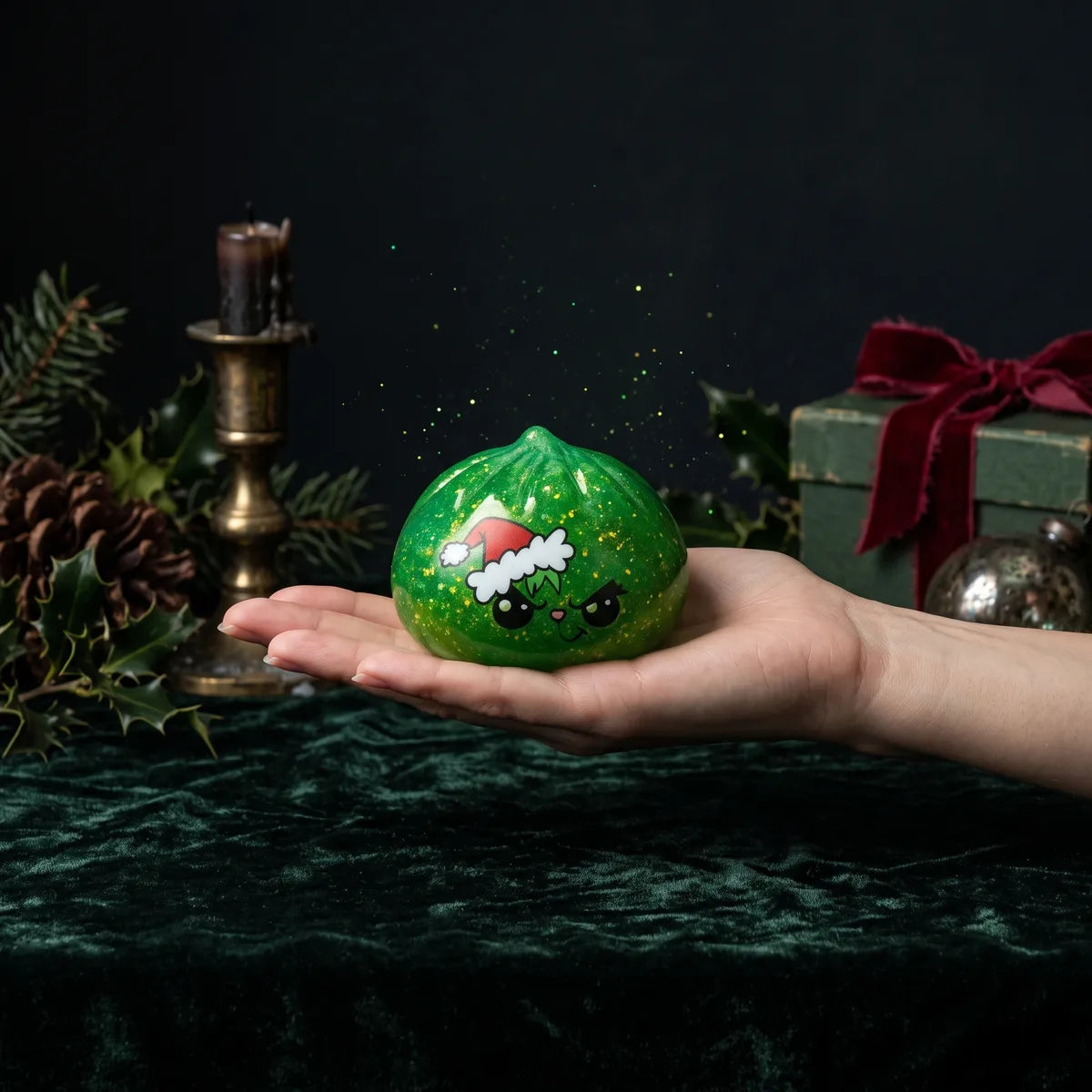 Grumpy Christmas Evil Dumpling Squishy resting on an open palm to show its real size