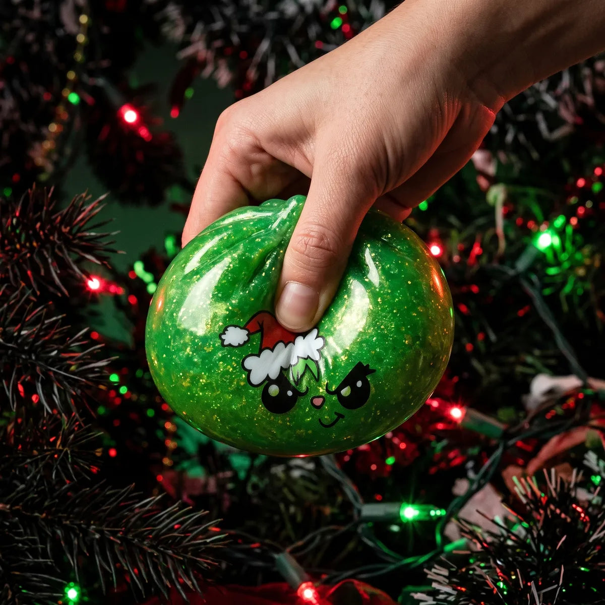 Hand squeezing the Grumpy Christmas Evil Dumpling Squishy