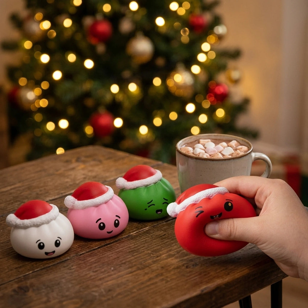 Hand squeezing the red Christmas hat dumpling squishy beside the white, pink and green ones