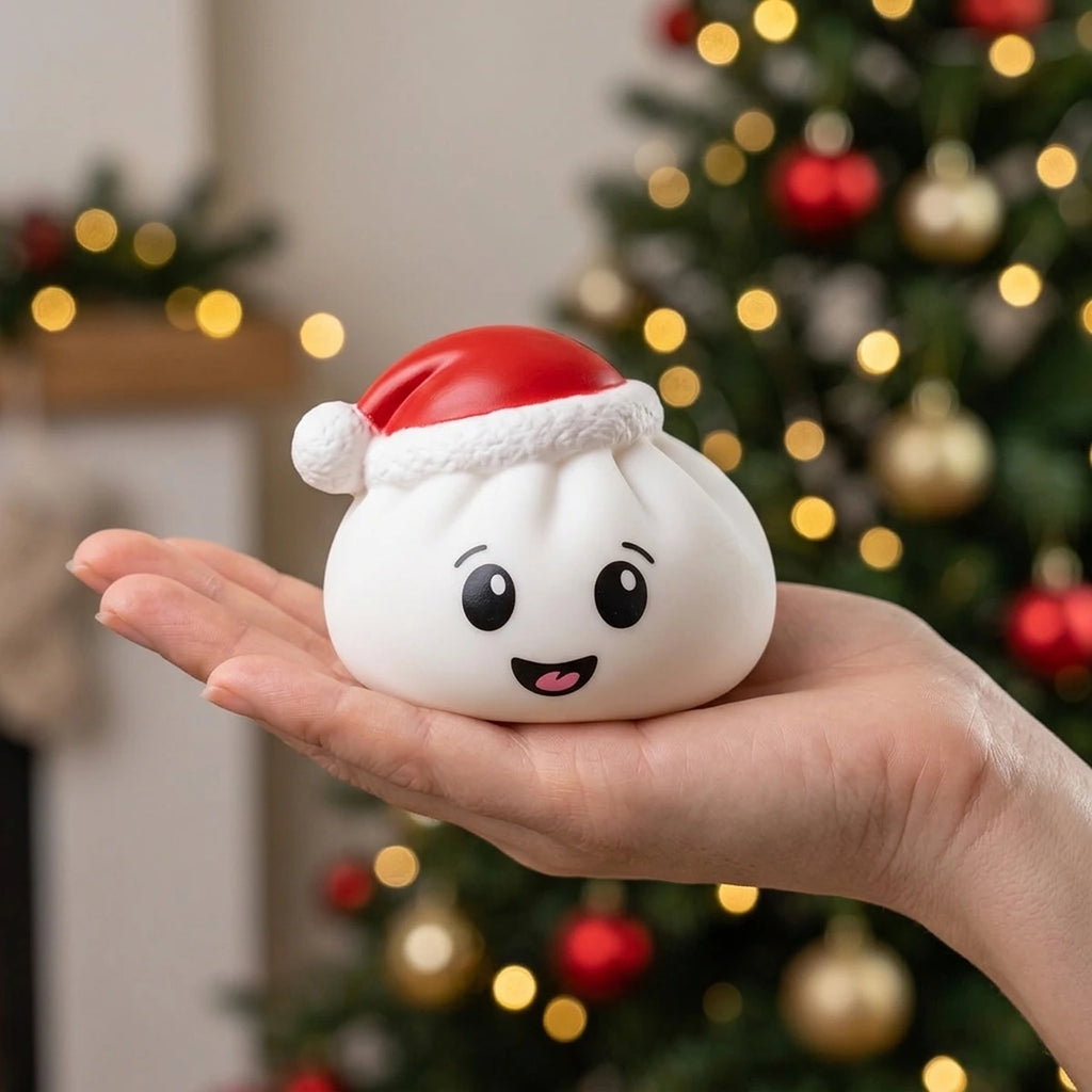 White Christmas hat dumpling squishy resting on an open palm to show its 7.5 cm size
