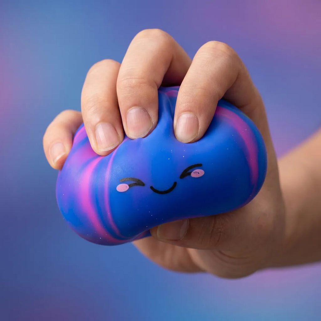 Hands playing with the colorful dumpling squishy mystery toy