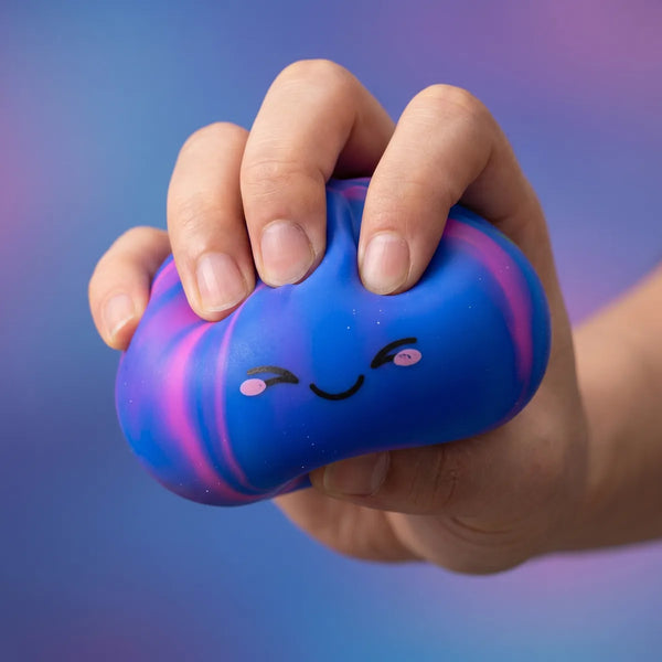 Hands playing with the colorful dumpling squishy mystery toy