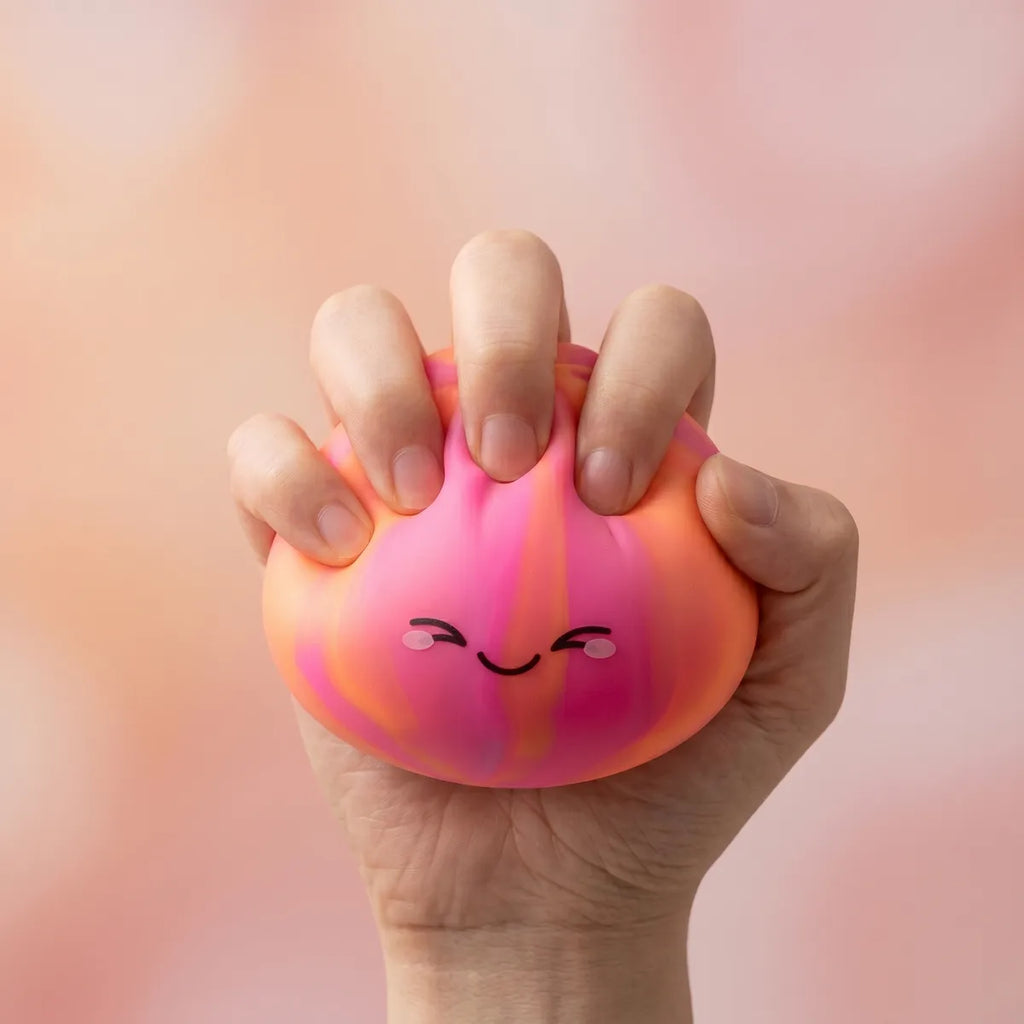 Colorful dumpling squishy being squeezed showing slow rising foam