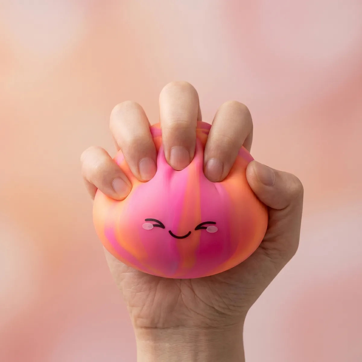Colorful dumpling squishy being squeezed showing slow rising foam