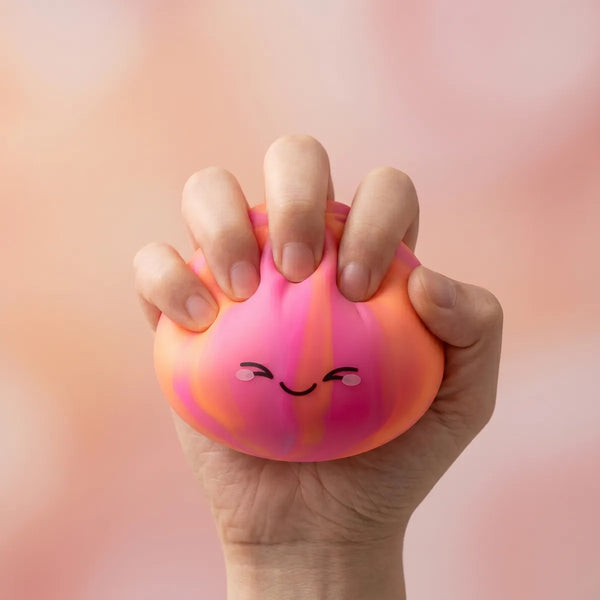 Colorful dumpling squishy being squeezed showing slow rising foam