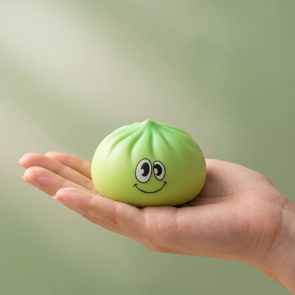 Dumpling squishy mystery bun fidget toy held in hand
