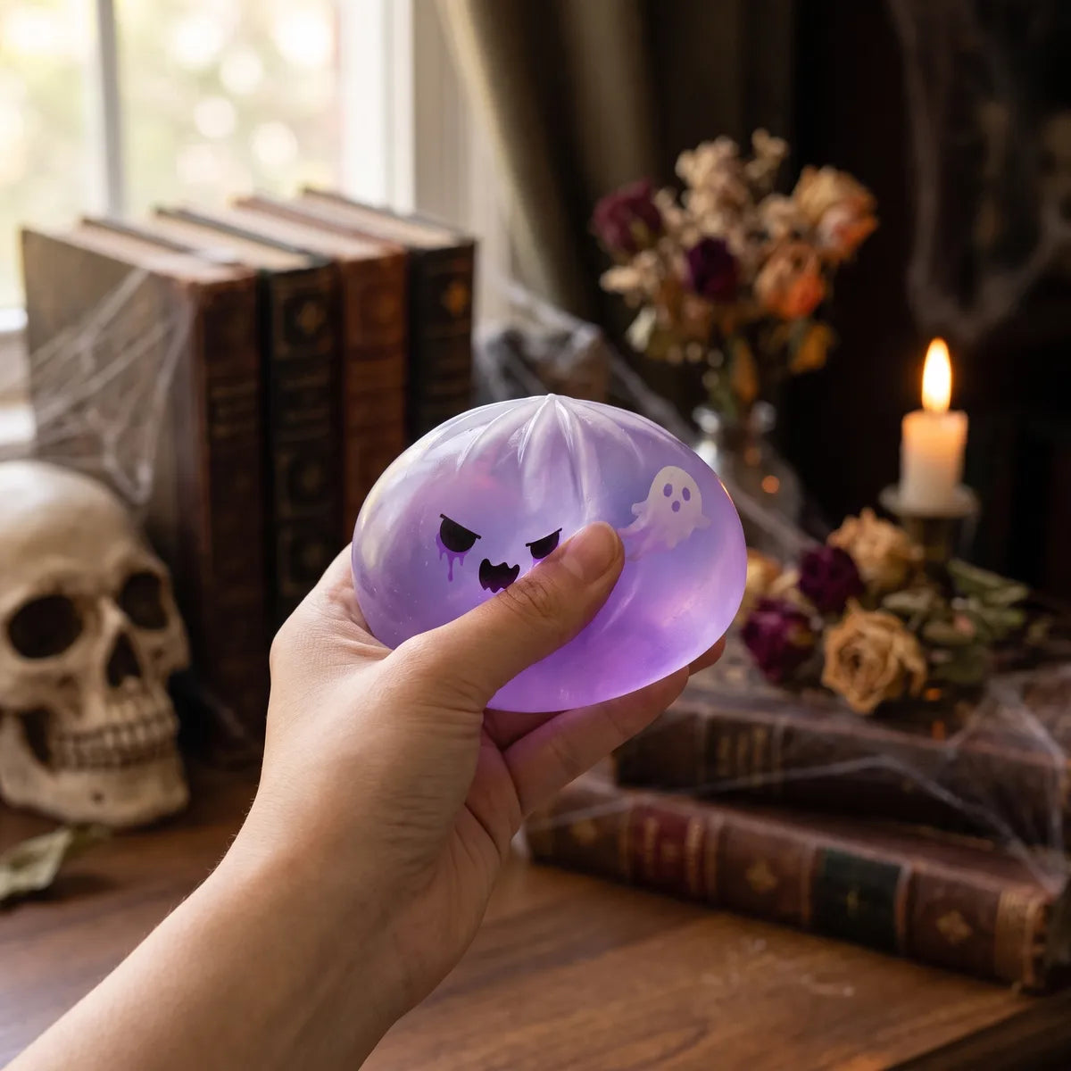 Person using a ghost dumpling squishy for stress relief
