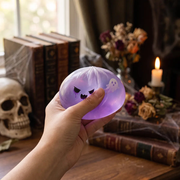 Person using a ghost dumpling squishy for stress relief