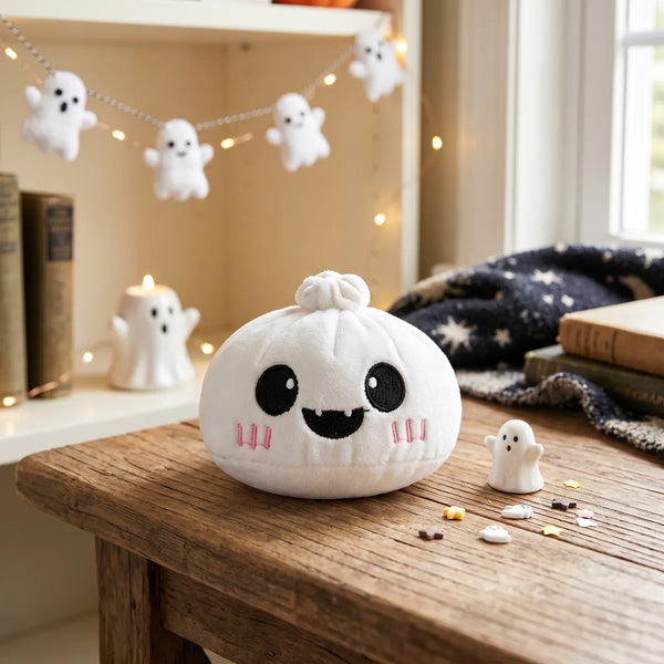 Moonlit Ghost Halloween Dumpling Squishy Plush displayed on a desk with little ghost garlands