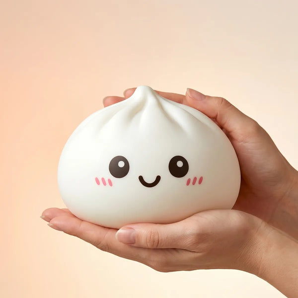 Giant dumpling squishy toy held to show its large size