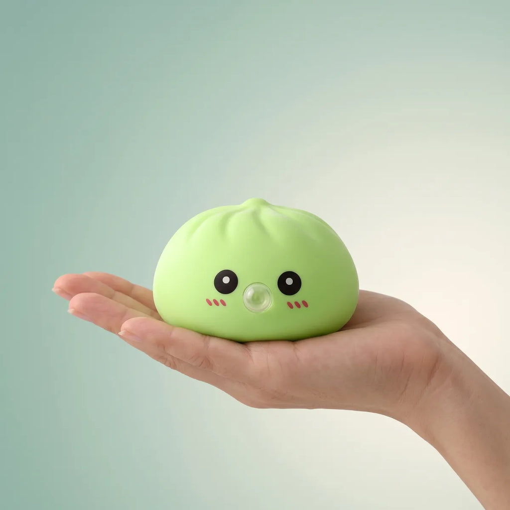Green blow dumpling squishy held in hand