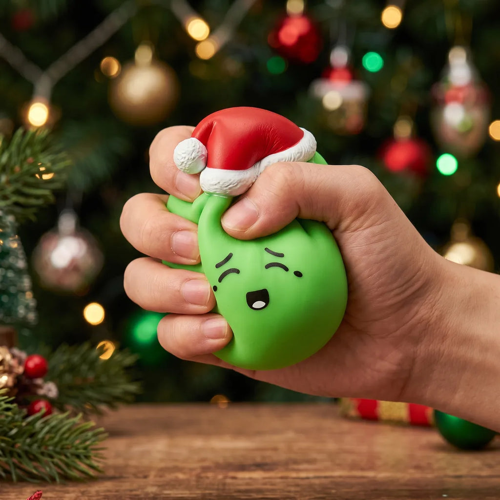Hand squeezing the Elf Green Christmas Hat Dumpling Squishy