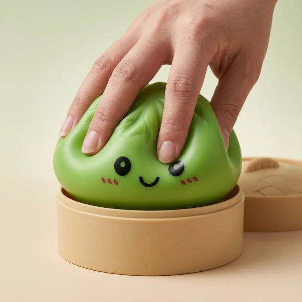 Green dumpling squishy being squeezed showing slow rising foam