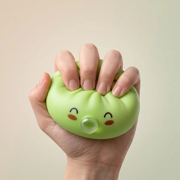 Hand squeezing a green rare blow dumpling squishy