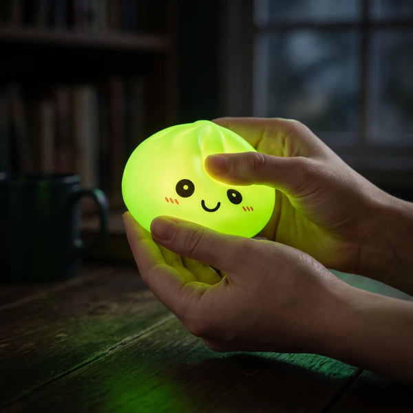 Green squishy dumpling light glowing softly in a dark room