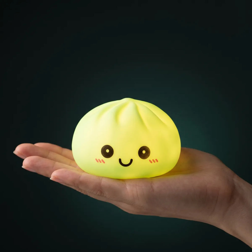 Green squishy dumpling light held in hand