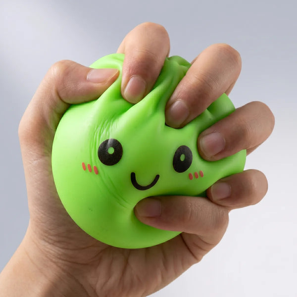 Hands playing with the green squishy dumpling light