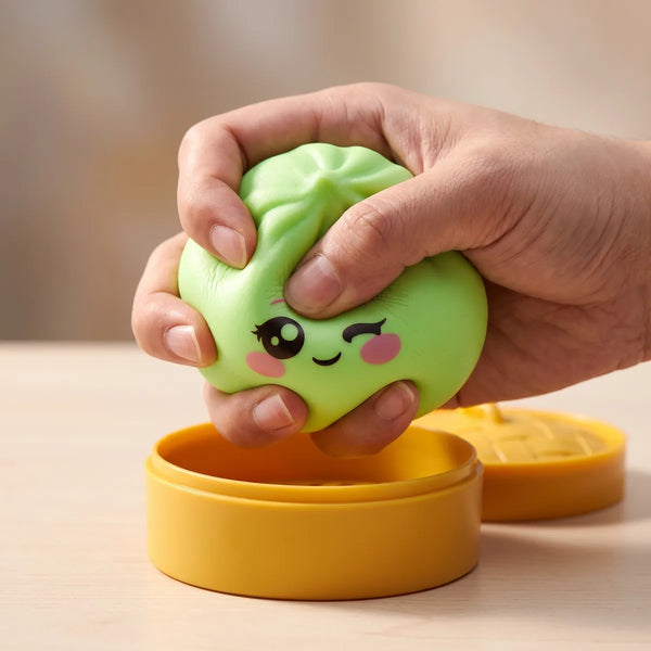 Pistachio Green Wink Dumpling Squishy pressed flat under a hand before it slowly rises back