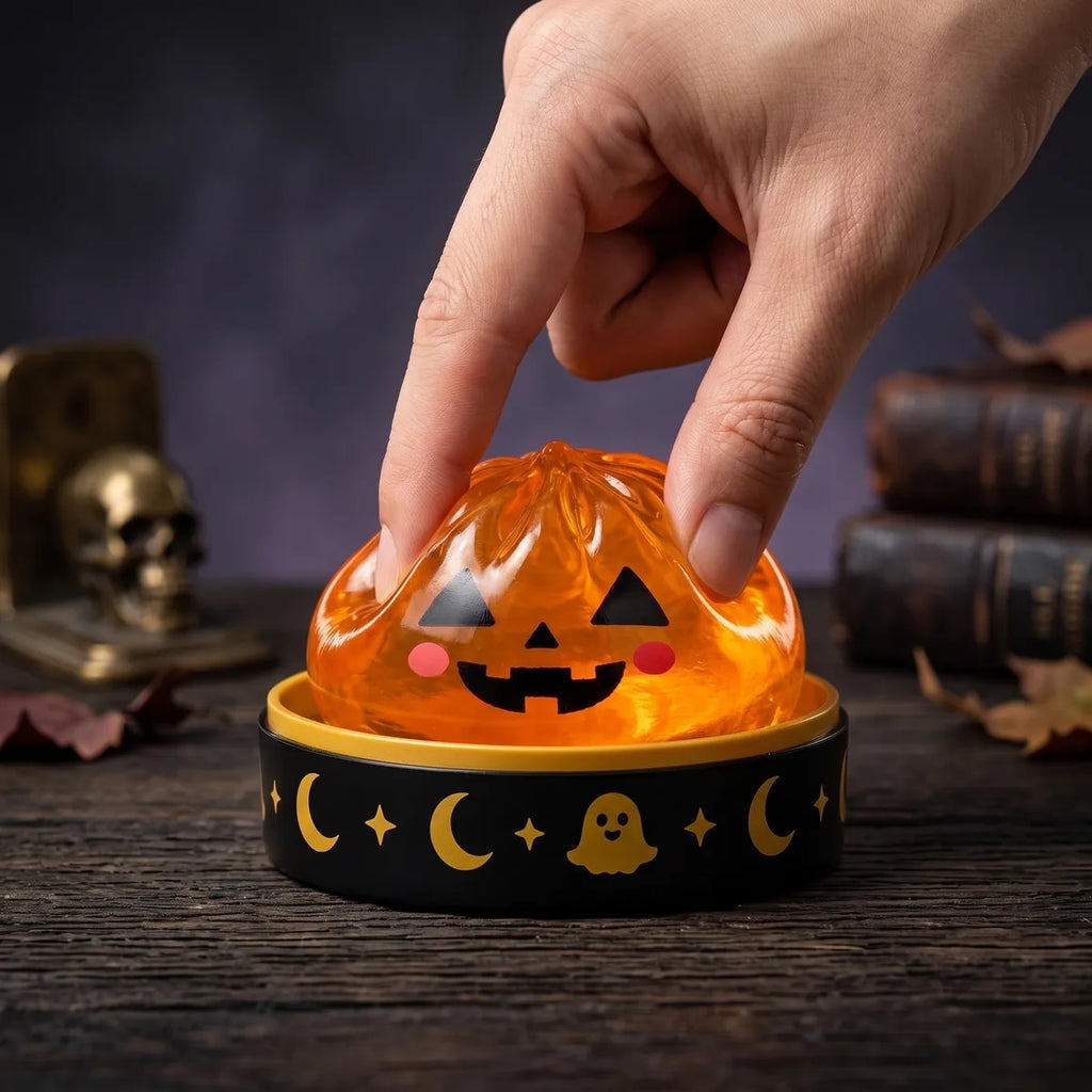 Halloween dumpling squishy from the set squeezed flat to show its slow rising rebound