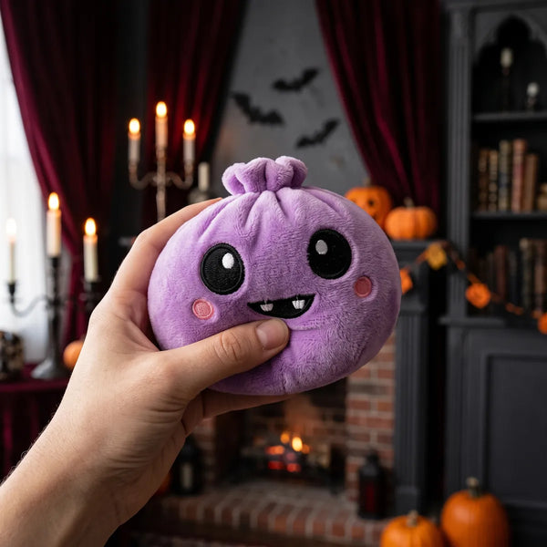 Person squeezing the Velvet Halloween Vampire Dumpling Squishy Plush as a fidget toy in a gothic candlelit room