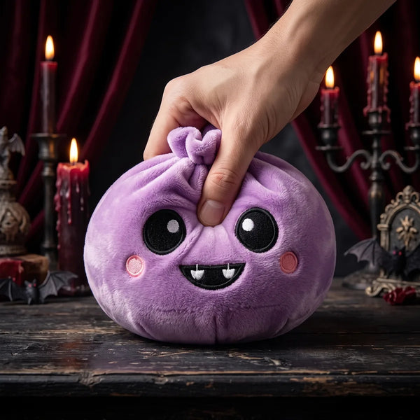 Hand squeezing the Velvet Halloween Vampire Dumpling Squishy Plush