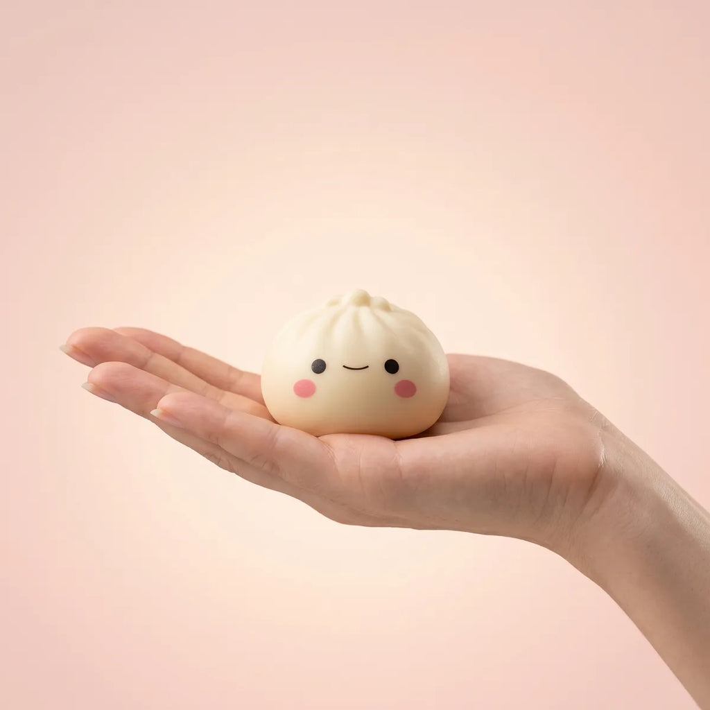 Japanese dumpling squishy held in hand to show its mini size
