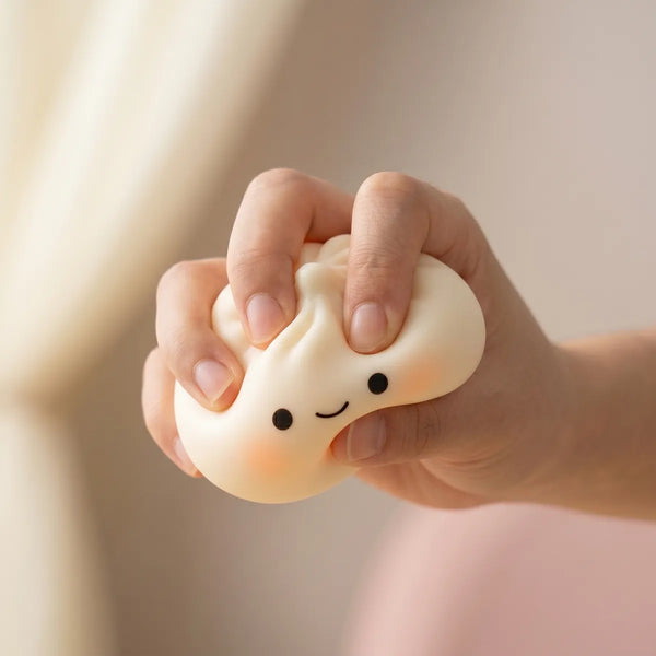 Japanese dumpling squishy being squeezed showing slow rising foam