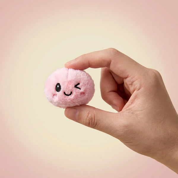 Keychain plush dumpling squishy clipped onto a bag
