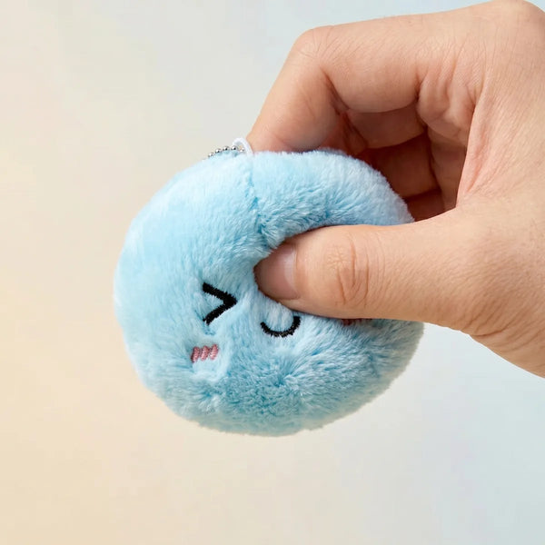 Keychain plush dumpling squishy being squeezed showing slow rising foam