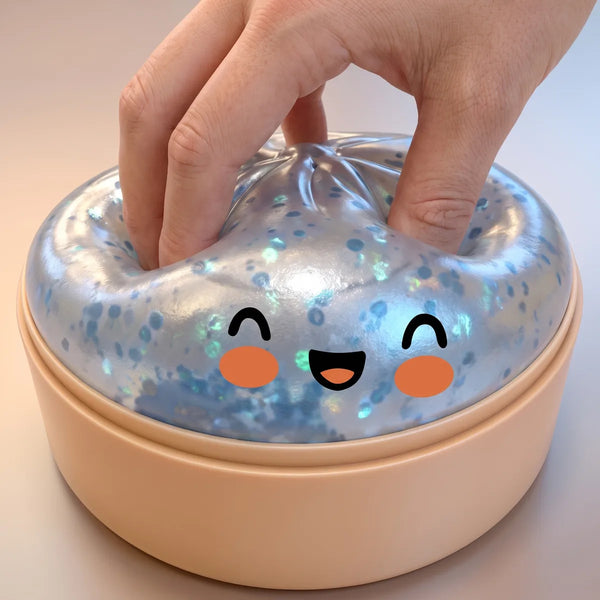 Hand squeezing a light blue sparkle dumpling squishy