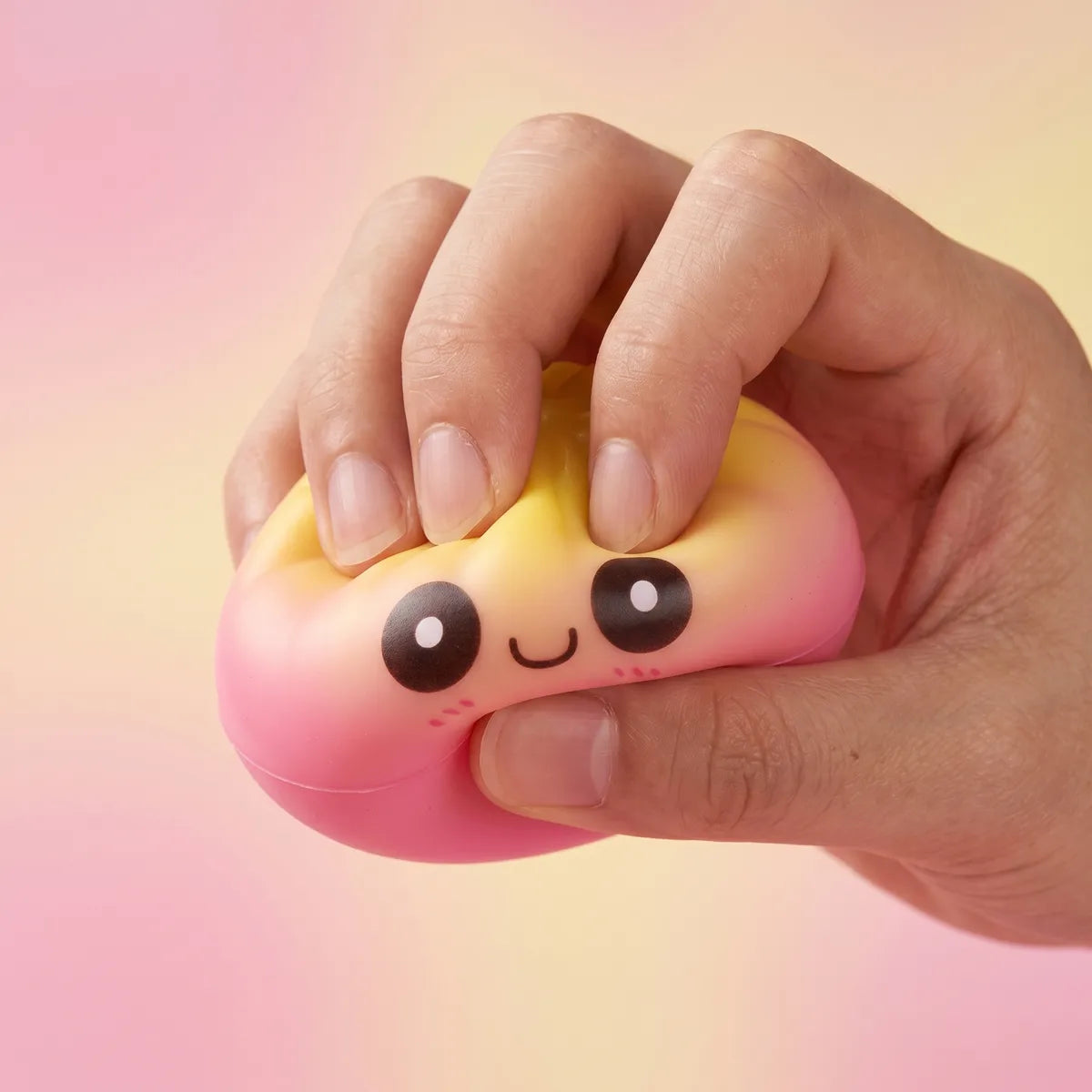 Hands playing with the mini dumpling squishy toy mystery set