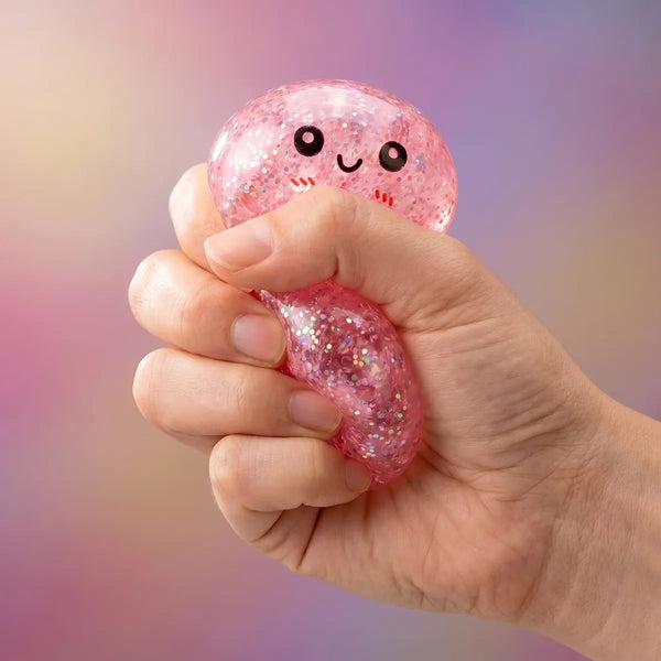 Hands playing with the mini metallic dumpling squishy
