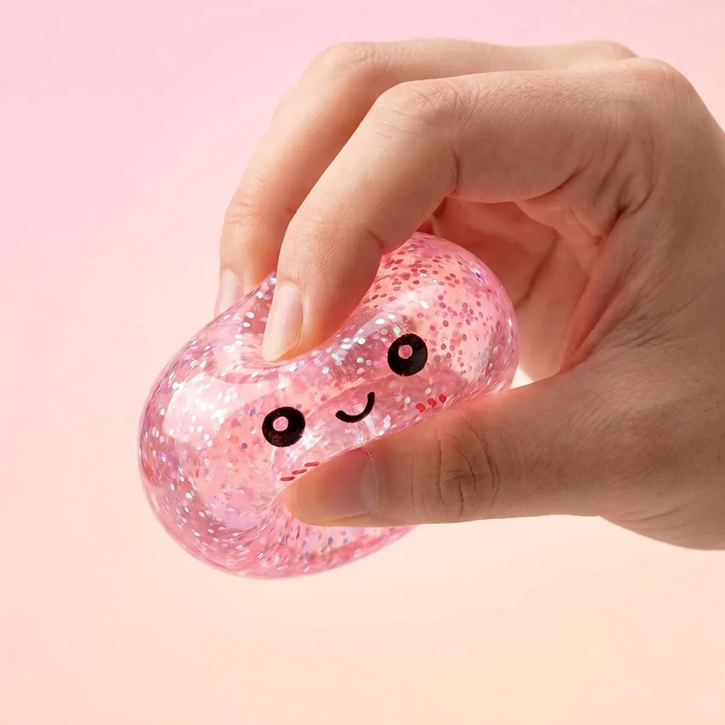 Mini metallic dumpling squishy being squeezed showing slow rising foam