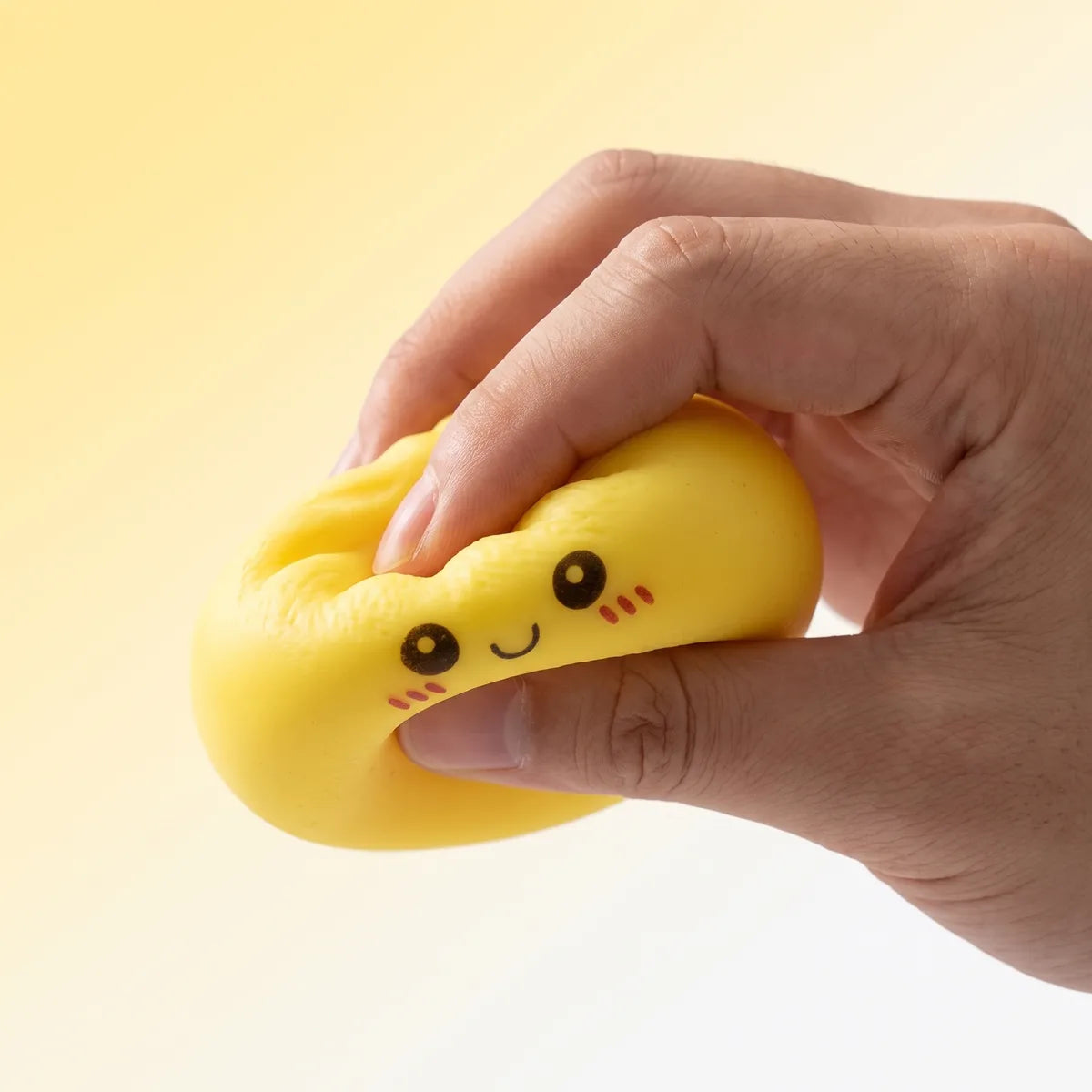 Hands playing with a pile of mini mystery squishy dumplings