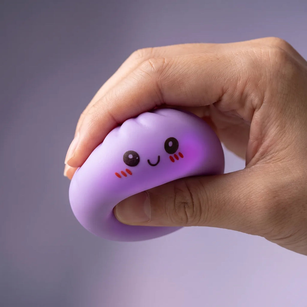 Mini mystery squishy dumpling being squeezed showing slow rising foam