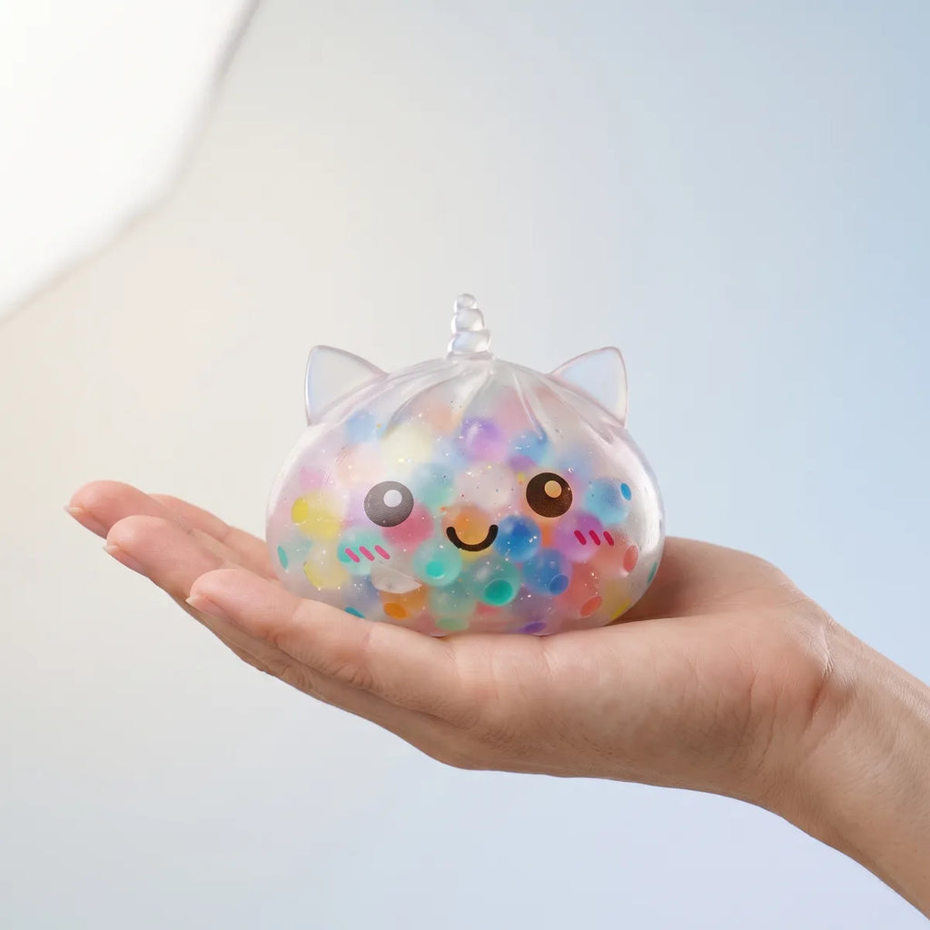 Hand holding the 9 cm multicolor unicorn bubble dumpling squishy to show its real size