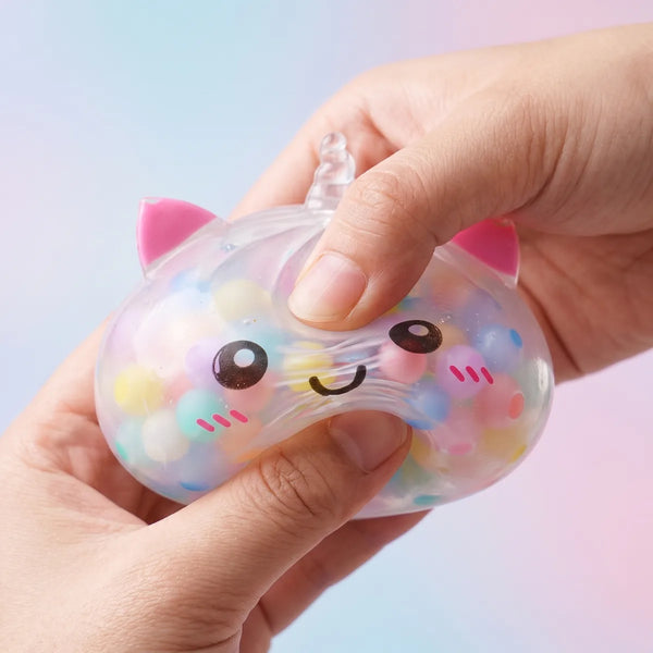 Multicolor unicorn bubble dumpling squishy squeezed to show the beads shifting under the clear skin