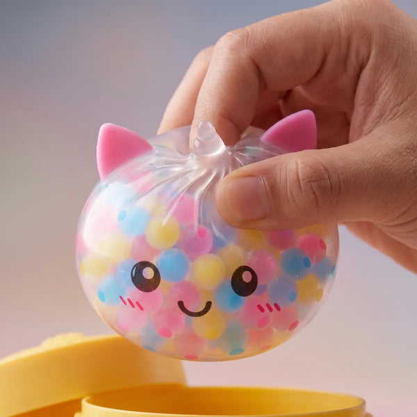 Close up squeeze showing the pastel bubble beads packed inside the unicorn dumpling squishy