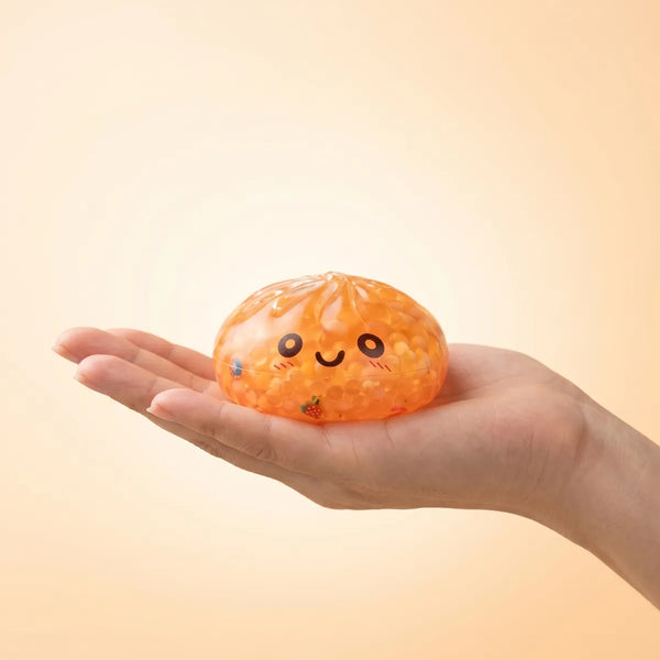 Mystery bubble dumpling squishy held in hand lifestyle shot