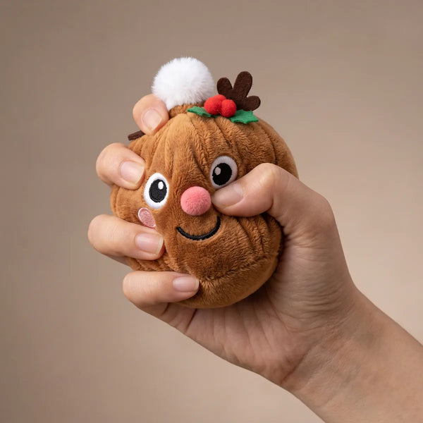 Hand squeezing the Holiday Mystery Christmas Dumpling Squishy Plush