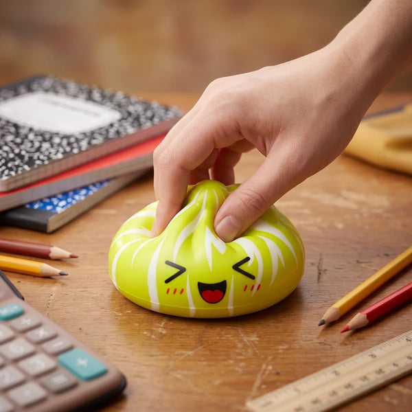 Hand squeezing a mystery cute dumpling squishy to show its slow rise