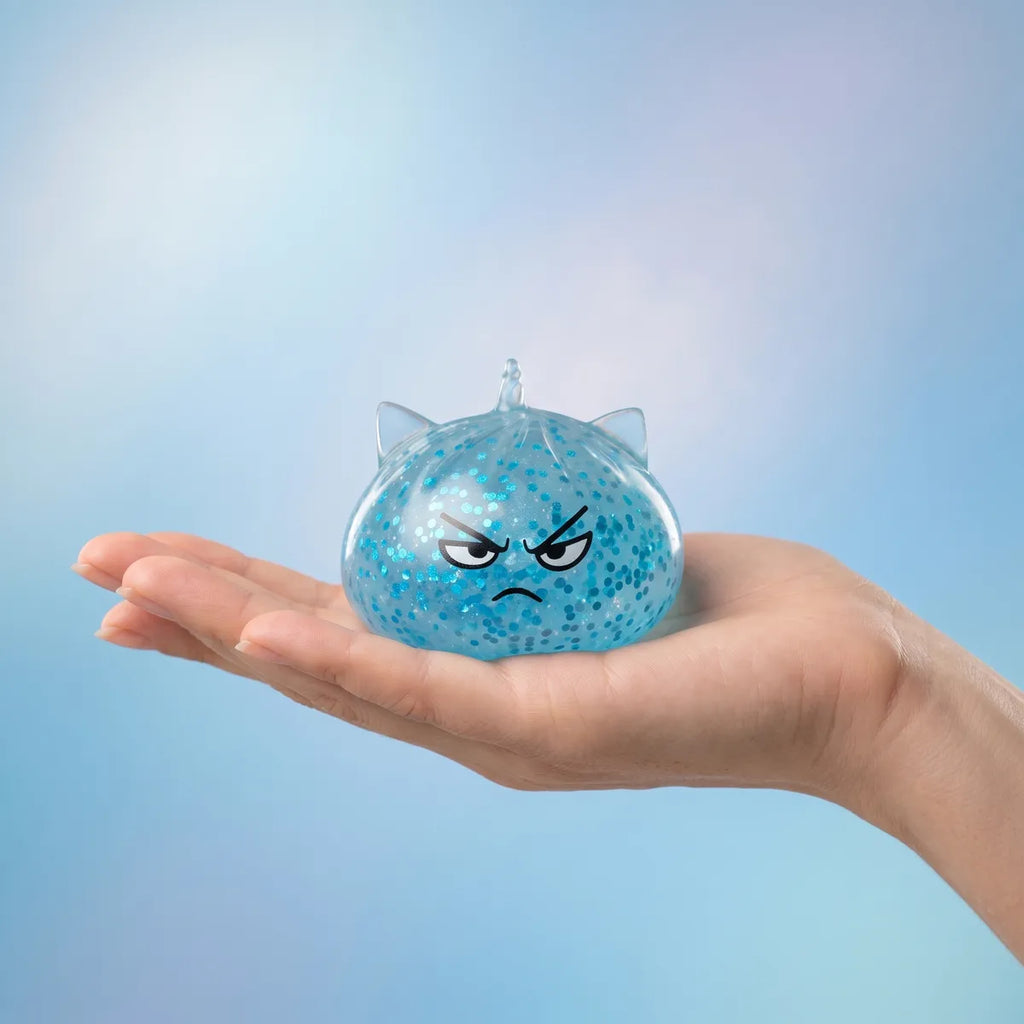 Unicorn glitter mystery dumpling squishy held in hand